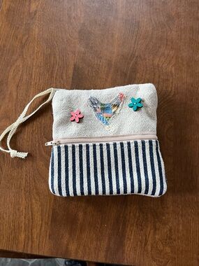 Canvas wristlet with chicken pattern and stripes .